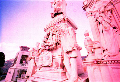 Low angle view of cross statue against sky