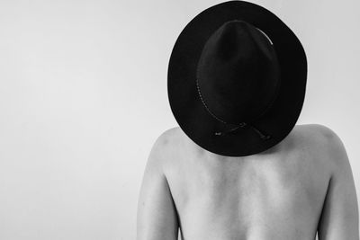 Rear view of shirtless man against white background