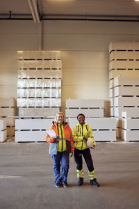 Portrait of smiling multiracial female coworkers standing in distribution warehouse