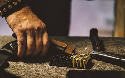 Cropped hand of man holding metal
