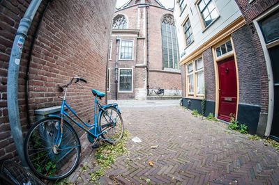 Bicycle parked on street by building