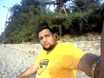 Portrait of young man standing on beach