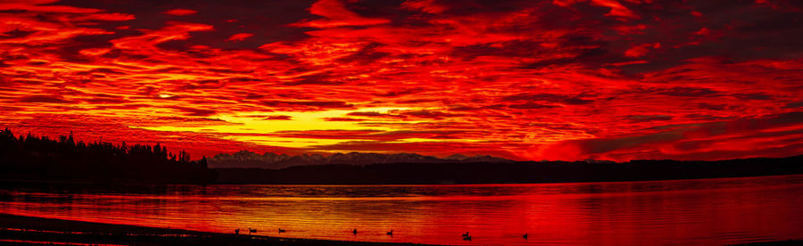 Scenic view of lake against orange sky