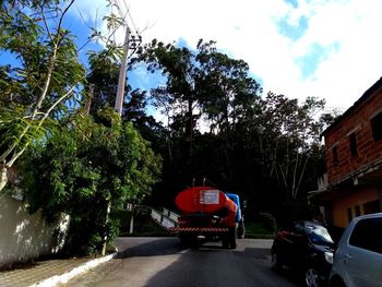 Car on street in city against sky