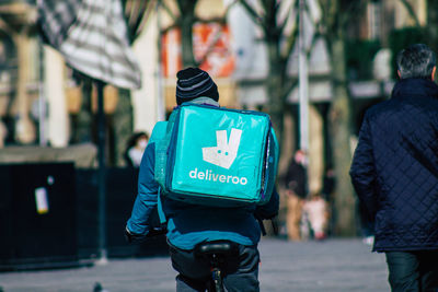 Rear view of man walking on street