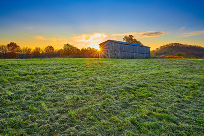 Scenic view of field against sky during sunset