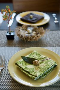 High angle view of easter egg on green napkin in plate