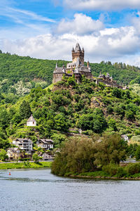 The reichsburg cochem on a hill above the mosel river.