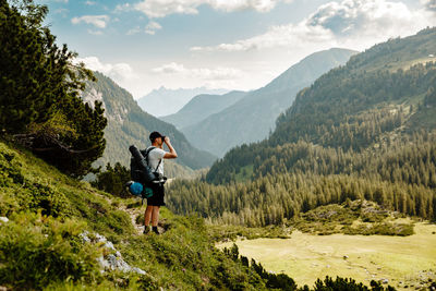 Rear view of man standing on mountain