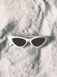 High angle view of sunglasses on beach
