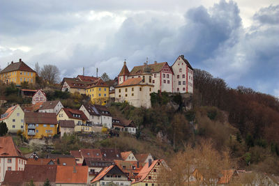 View of a medieval castle on the top of the mountain against cloudy sky
