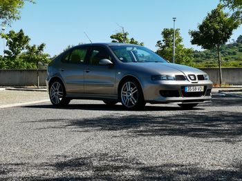 Car on street against blue sky