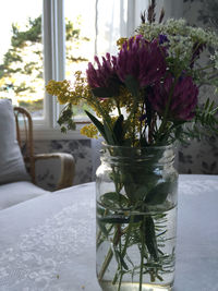 Close-up of flower vase on table at home