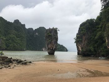 Rock formations in sea against sky