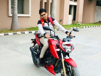 Young woman riding motorcycle on street in city