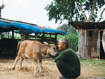 Full length of man touching calf