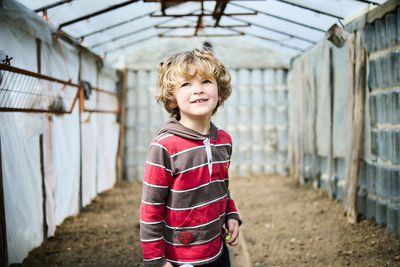 Portrait of happy boy standing outdoors