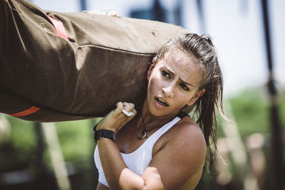 Woman carrying brute ball while standing outdoors