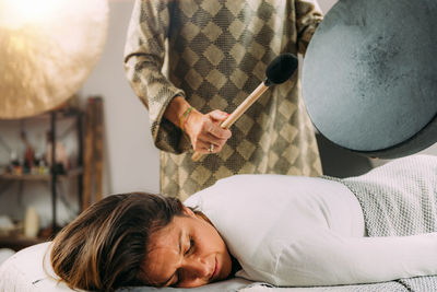 Playing moon drum in a sound healing therapy session