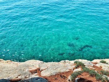 High angle view of rocks by sea