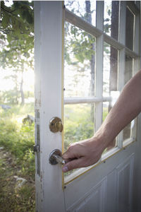 Cropped image of man holding door handle