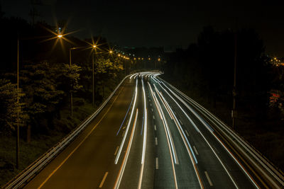 High angle view of light trails on highway at night