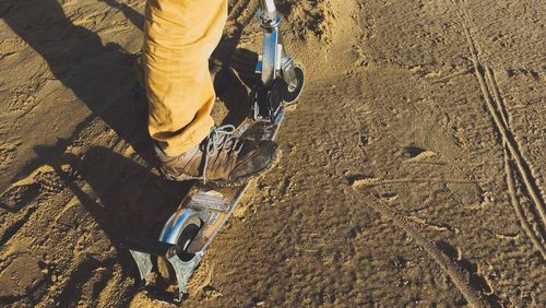 Low section of man standing on tiled floor