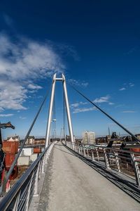 View of suspension bridge against cloudy sky