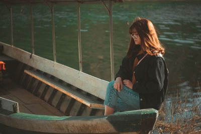 Full length of woman sitting outdoors