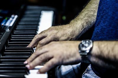 Close-up of man playing piano