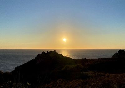 Scenic view of sea against clear sky during sunset