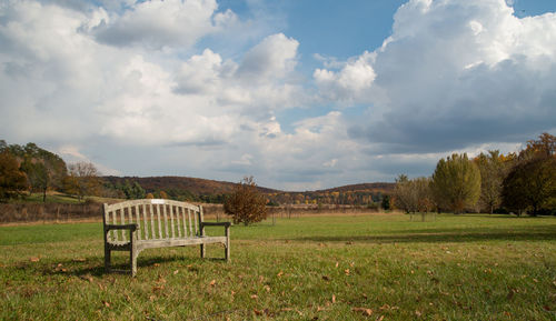 Scenic view of grassy field against cloudy sky