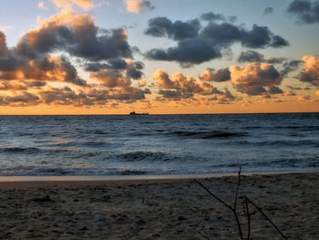 Scenic view of beach against sky during sunset