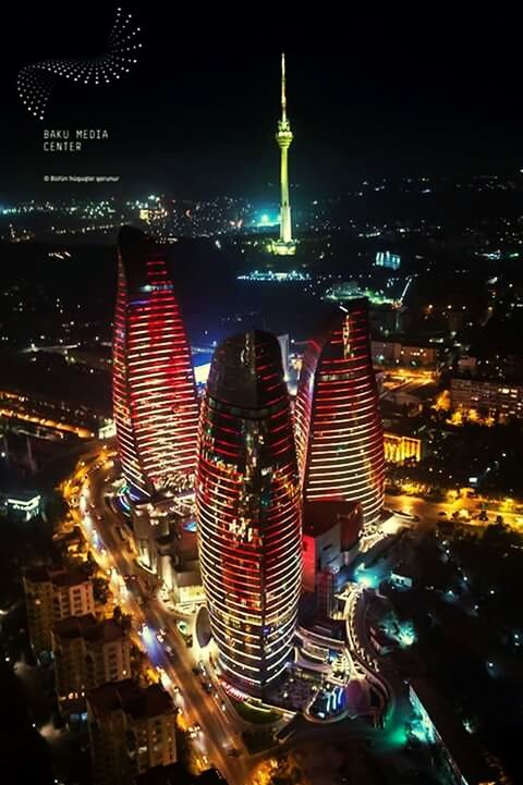 illuminated, night, city, architecture, building exterior, built structure, cityscape, skyscraper, tall - high, tower, capital cities, modern, travel destinations, crowded, famous place, office building, high angle view, city life, international landmark, tourism