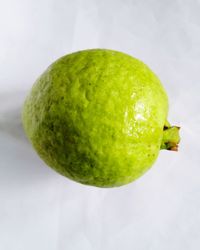 High angle view of apple on table against white background