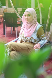 Young woman sitting outdoors