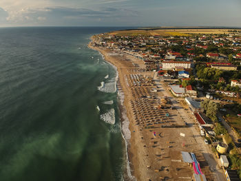 High angle view of buildings by sea against sky