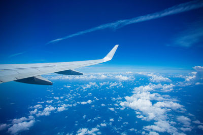 Aerial view of airplane flying in sky