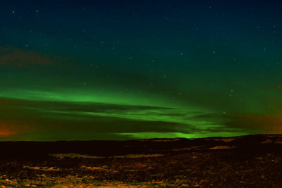 Scenic view of landscape against sky at night