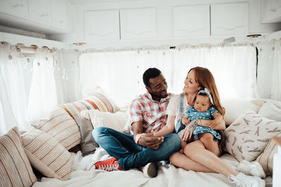 Cheerful family siting in camper van