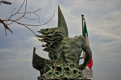Low angle view of neptune statue against sky in torre del greco, italy