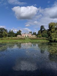 Scenic view of lake against cloudy sky