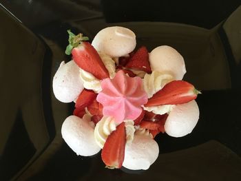 High angle view of flowers and fruits on plate