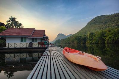 Scenic view of lake by buildings against sky