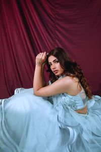 Beautiful young woman lying on bed