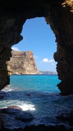 Scenic view of sea against rock formation