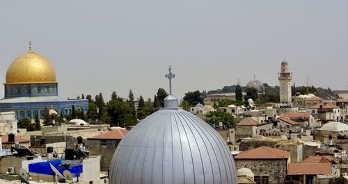 Panoramic view of buildings in city against sky