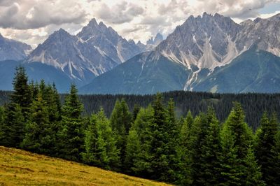 Scenic view of mountains against cloudy sky