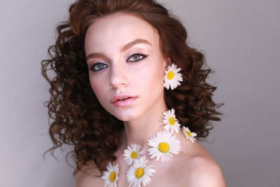 Close-up portrait of teenage girl wearing flowers