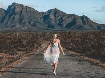 Image of a blonde young girl posing in from of bluff knoll-. western australia